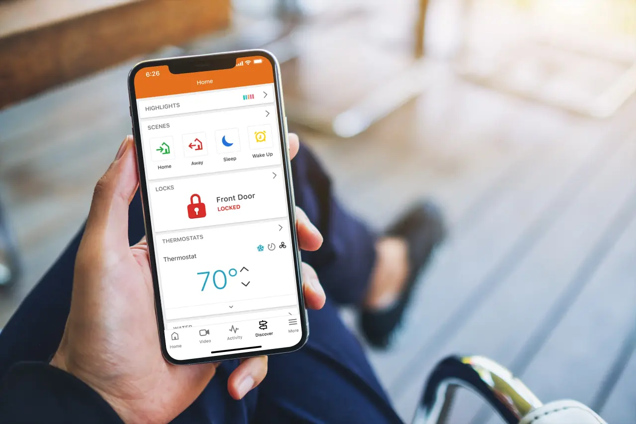 Alarm.com app on a phone showing arm and disarm controls